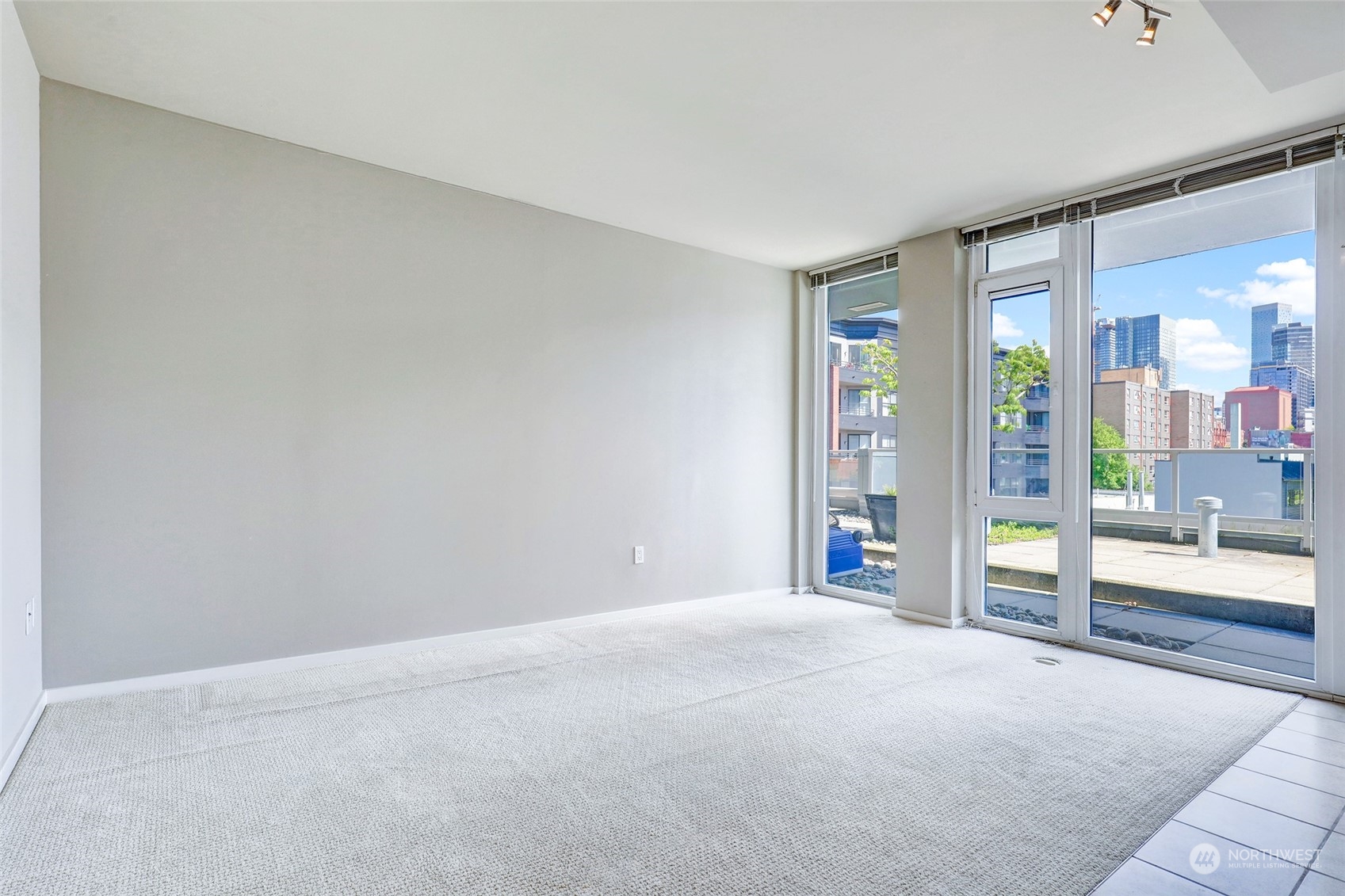 76 Cedar Street, Unit 710 Seattle, WA 98121 - Photo 7 of 20 a view of an empty room with glass door