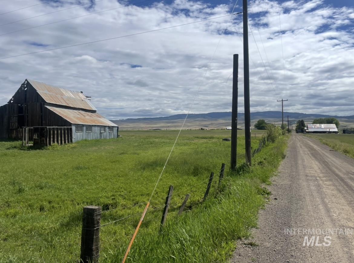 2250 Moritz Lane Indian Valley, ID 83632 - Photo 5 of 49 View of dirt / gravel road with a barn, a rural view, and a mountain view