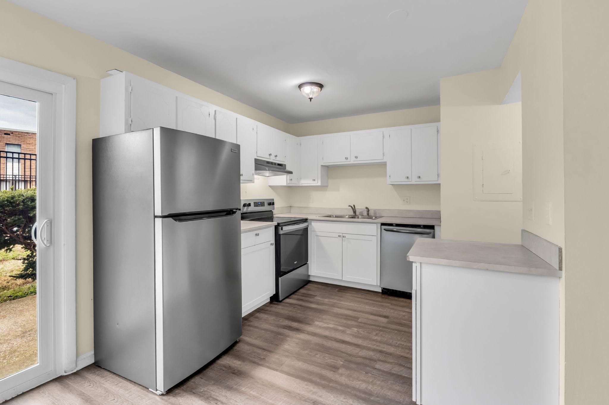 370 Wallace Road, Unit F5 Nashville, TN 37211 - Photo 4 of 28 a kitchen with a refrigerator sink and white cabinets