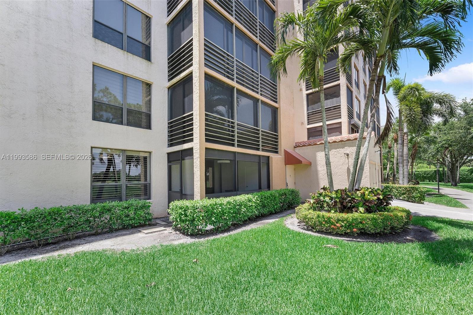 7225 Promenade Drive, Unit 102 Boca Raton, FL 33433 - Photo 15 of 21 a view of a house with a yard and plants