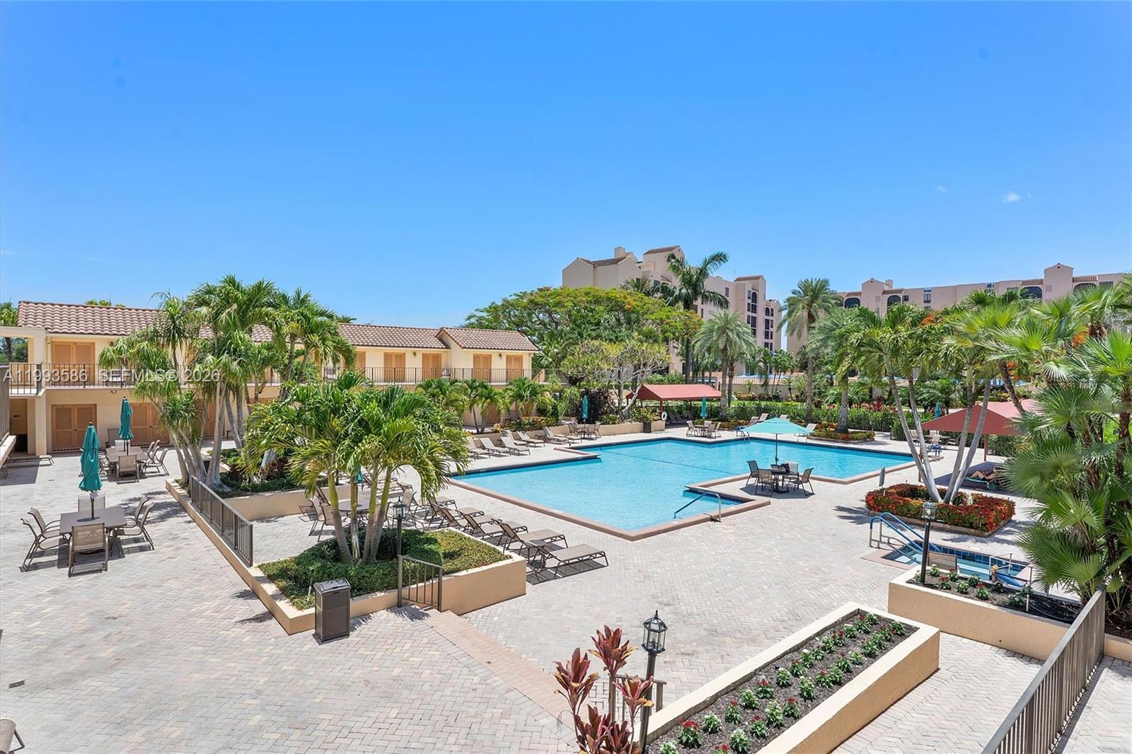 7225 Promenade Drive, Unit 102 Boca Raton, FL 33433 - Photo 17 of 21 a view of a swimming pool with chairs