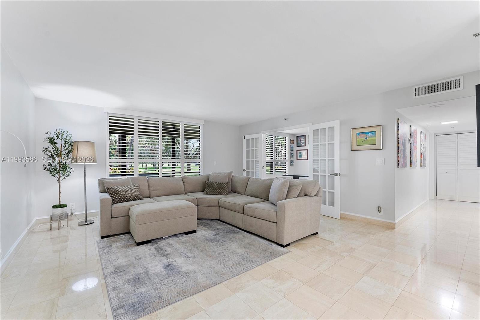 7225 Promenade Drive, Unit 102 Boca Raton, FL 33433 - Photo 2 of 21 a living room with furniture and a potted plant