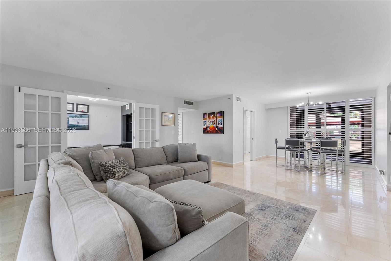 7225 Promenade Drive, Unit 102 Boca Raton, FL 33433 - Photo 6 of 21 a living room with furniture and wooden floor