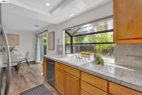 a kitchen with stainless steel appliances granite countertop sink stove and table