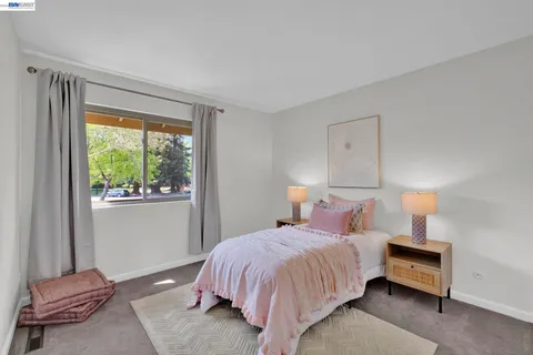 a bedroom with a bed and window