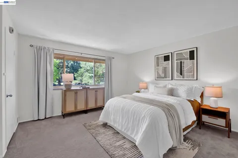 a bedroom with a bed and a couch