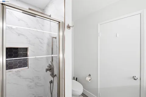 a bathroom with a shower and a toilet