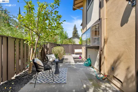 a view of a patio with table and chairs and potted plants