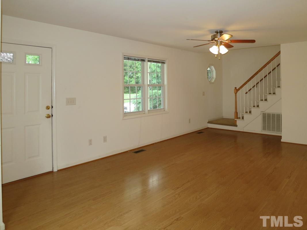 303 West Poplar Avenue, Unit B Carrboro, NC 27510 - Photo 3 of 16 a view of an empty room with a window