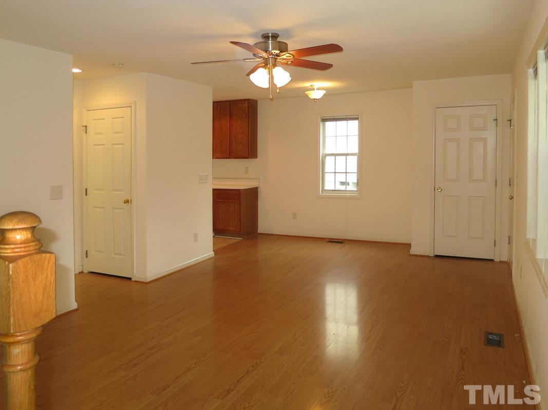 303 West Poplar Avenue, Unit B Carrboro, NC 27510 - Photo 4 of 16 a view of an empty room with window and wooden floor