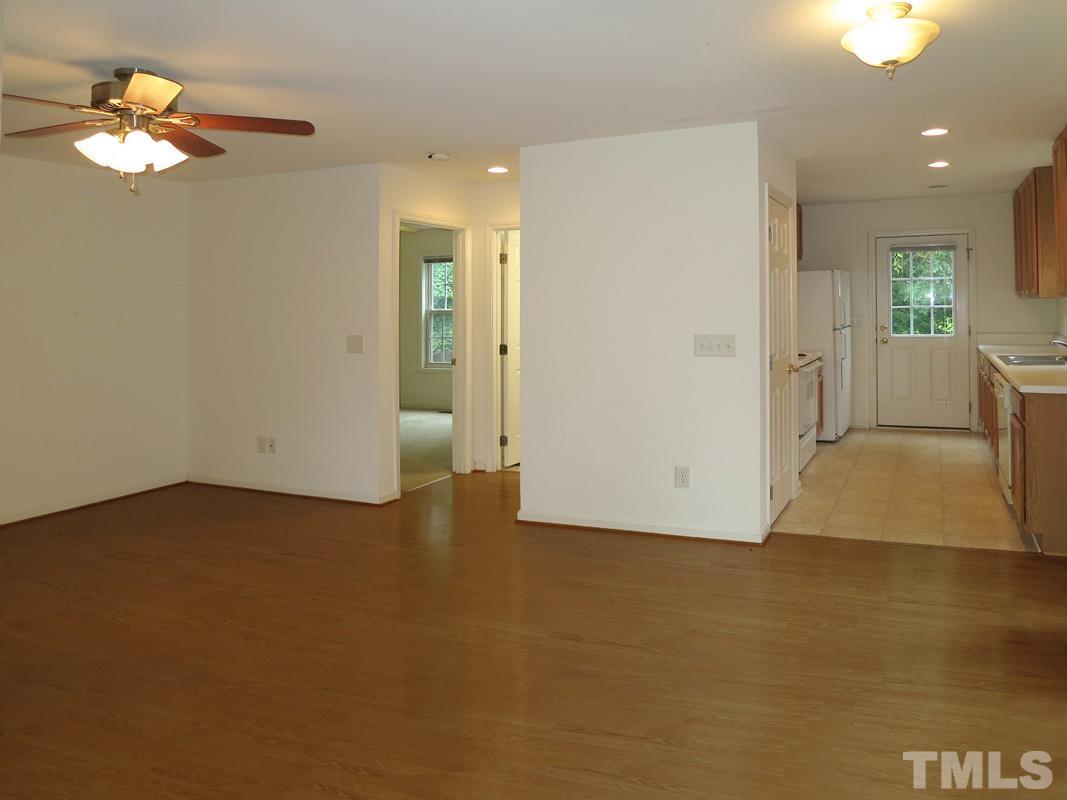 303 West Poplar Avenue, Unit B Carrboro, NC 27510 - Photo 5 of 16 wooden floor in an empty room with a window