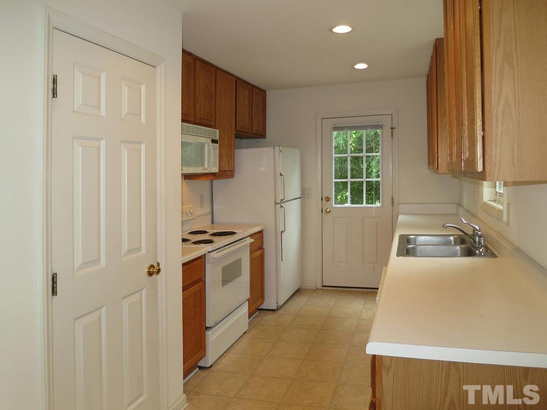 303 West Poplar Avenue, Unit B Carrboro, NC 27510 - Photo 6 of 16 a kitchen with stainless steel appliances granite countertop a refrigerator sink and stove
