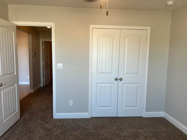 an empty room with closet area