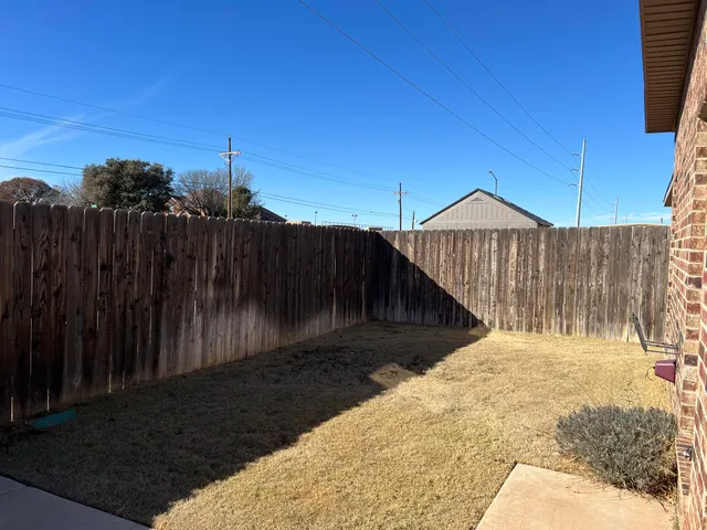 a view of street with wooden fence