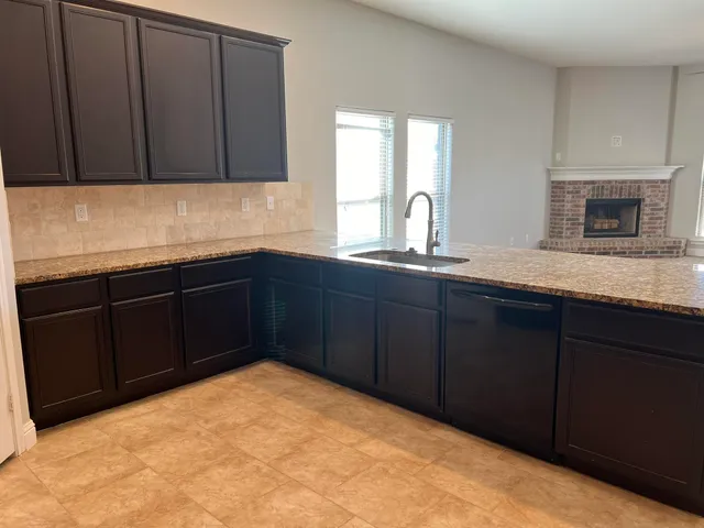 a kitchen with a sink and cabinets