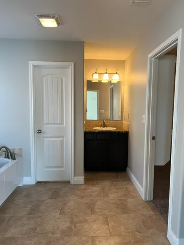 a view of room with a sink and mirror