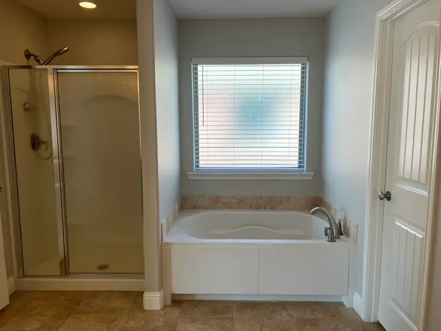 a white bath tub sitting next to a window