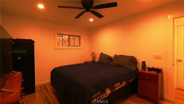 a bed sitting in a bedroom next to a lamp