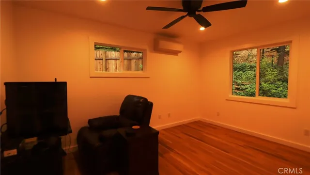 a view of workspace with wooden floor and windows