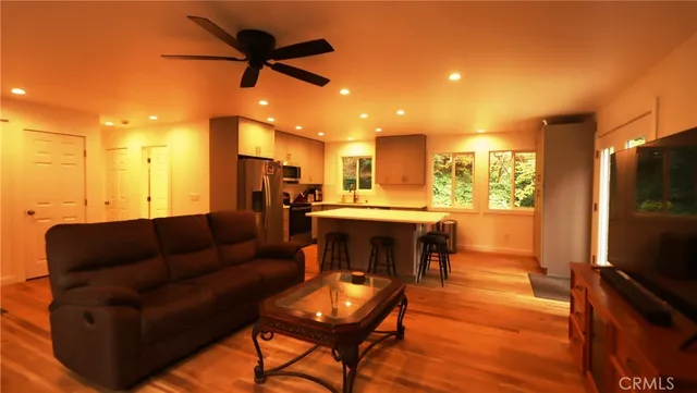 a living room with furniture and kitchen view