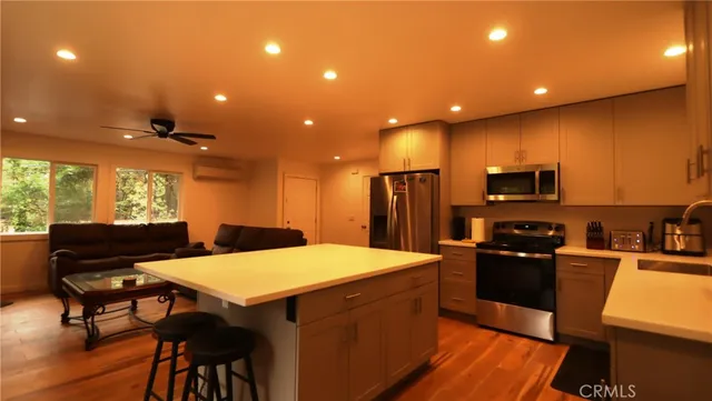 a kitchen with a table chairs refrigerator and microwave
