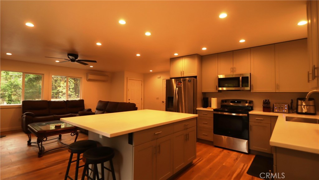 15815 Bottle Rock Road Middletown, CA 95461 - Photo 7 of 20 a kitchen with a table chairs refrigerator and microwave