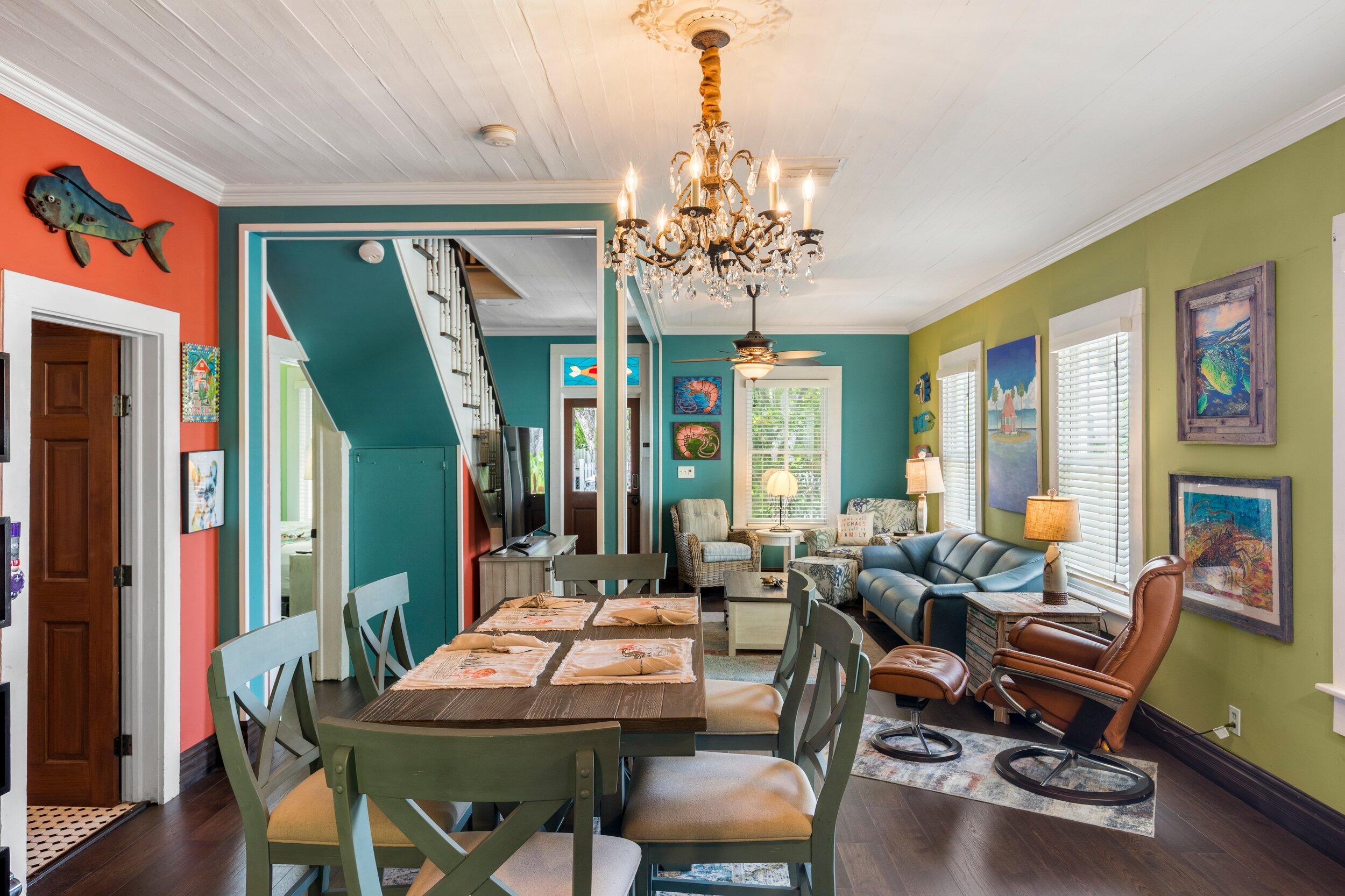 409 Grinnell Street Key West, FL 33040 - Photo 14 of 47 a view of a dining room with furniture wooden floor and chandelier