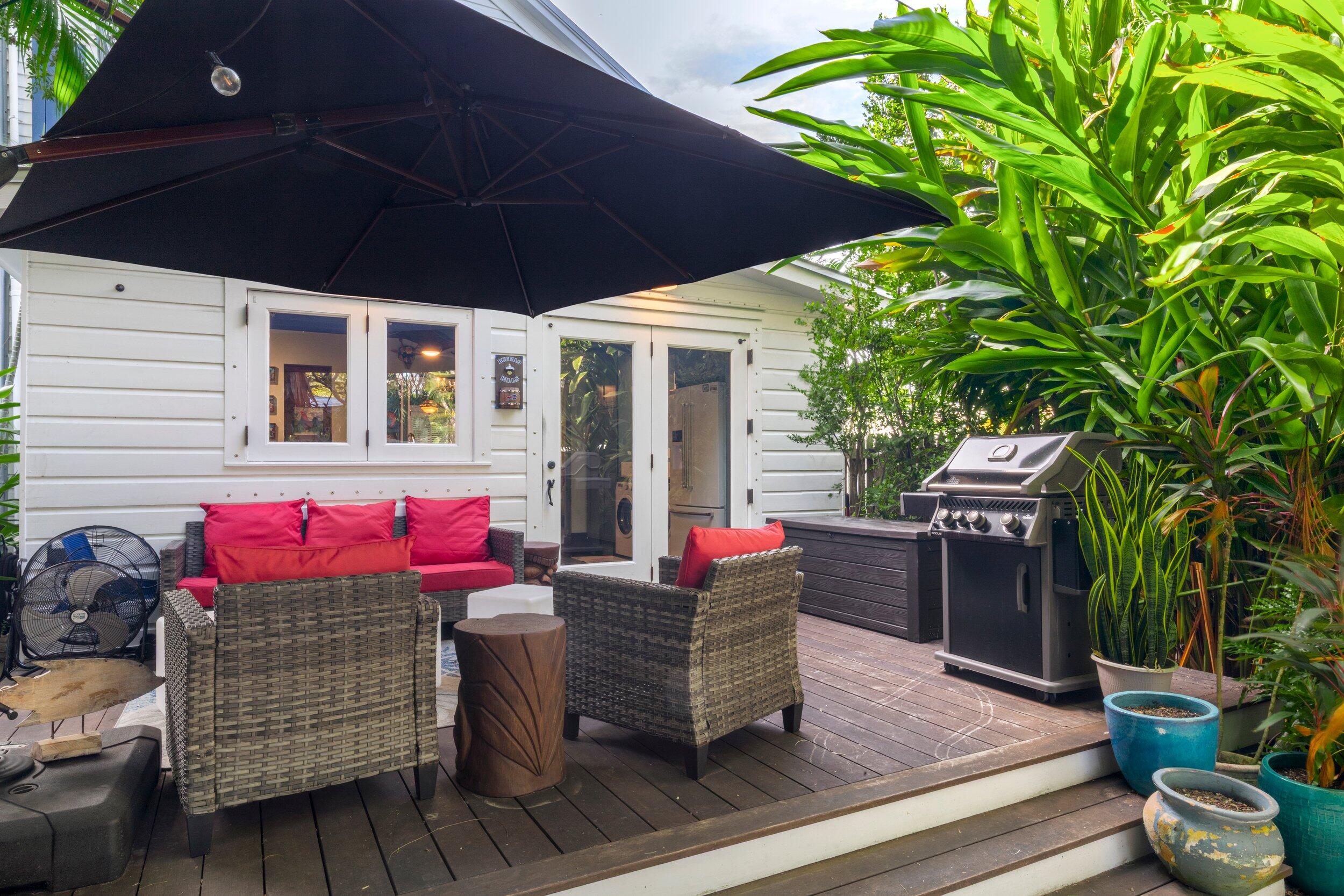 409 Grinnell Street Key West, FL 33040 - Photo 27 of 47 a patio with table and chairs and potted plants