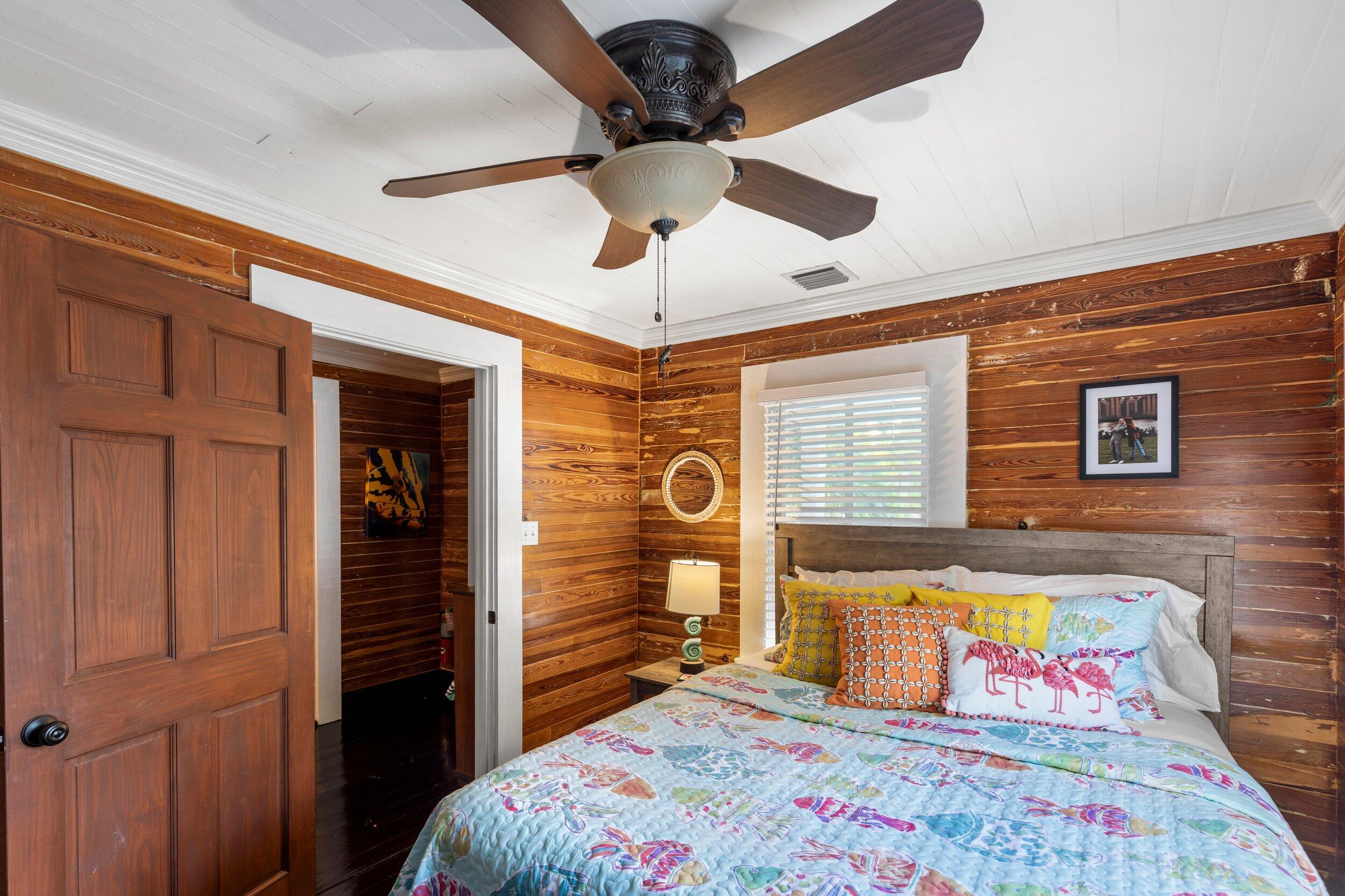 409 Grinnell Street Key West, FL 33040 - Photo 30 of 47 a bedroom with a bed and a chandelier