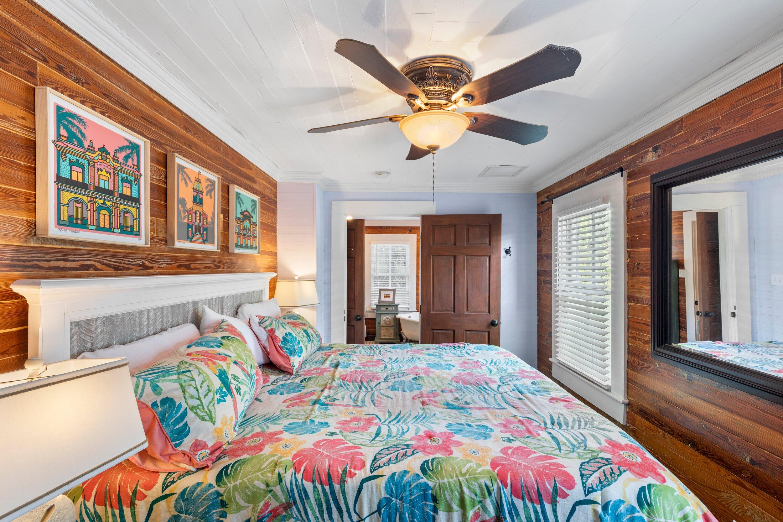 409 Grinnell Street Key West, FL 33040 - Photo 32 of 47 a bedroom with a bed and a chandelier