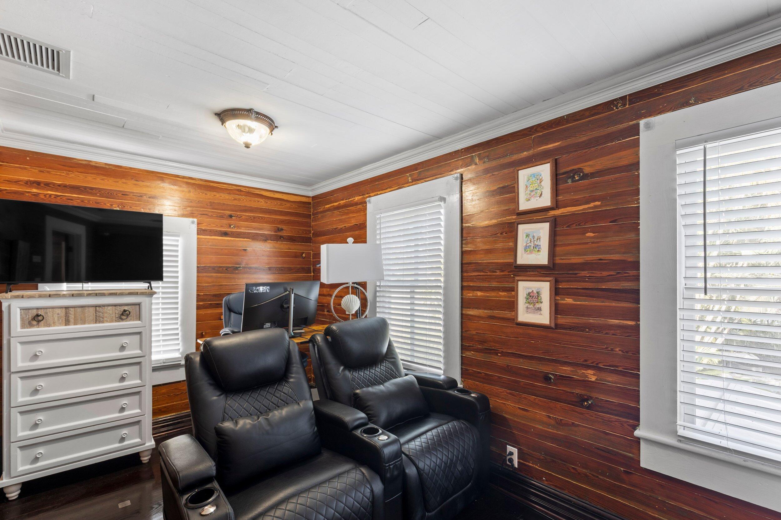 409 Grinnell Street Key West, FL 33040 - Photo 35 of 47 a projector room with a chair and a flat screen tv
