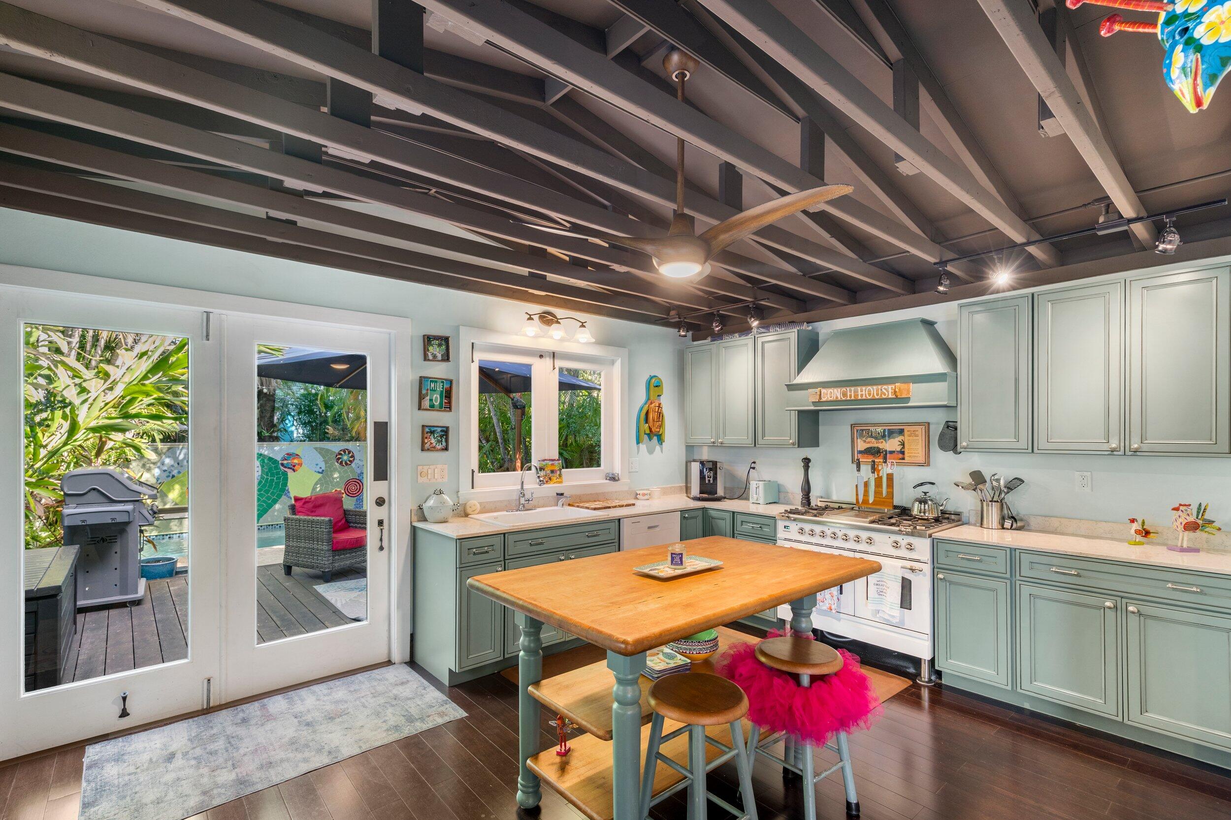 409 Grinnell Street Key West, FL 33040 - Photo 4 of 47 a dinning table and chairs in a kitchen