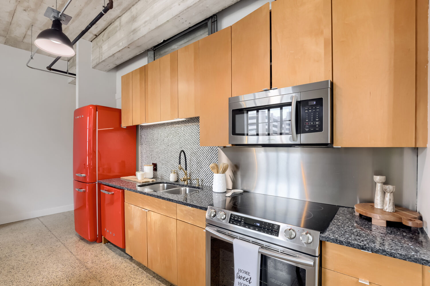 710 Colorado Street, Unit 4A Austin, TX 78701 - Photo 12 of 40 Also featureing a stainless steel electric range with built-in microwave above and stainless steel backdrop that makes clean up a breeze.