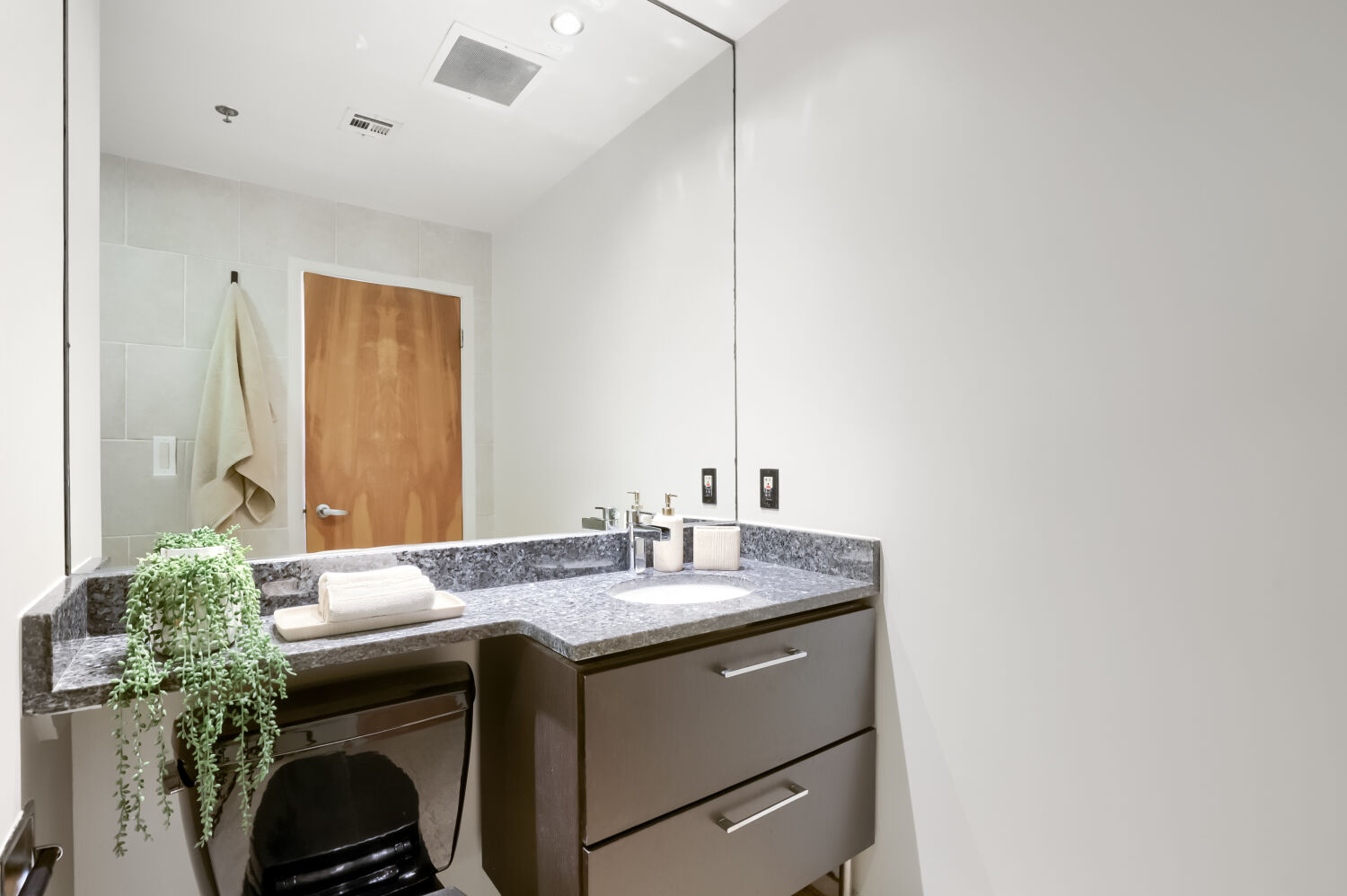 710 Colorado Street, Unit 4A Austin, TX 78701 - Photo 19 of 40 Stylish granite topped vanity with strorage cabinetry below.