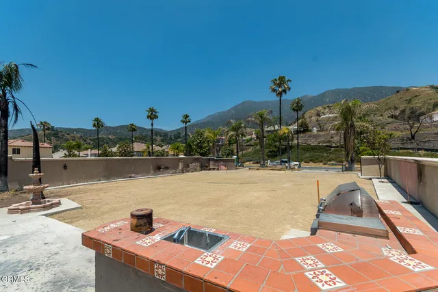 a view of a lake with couches and wooden floor
