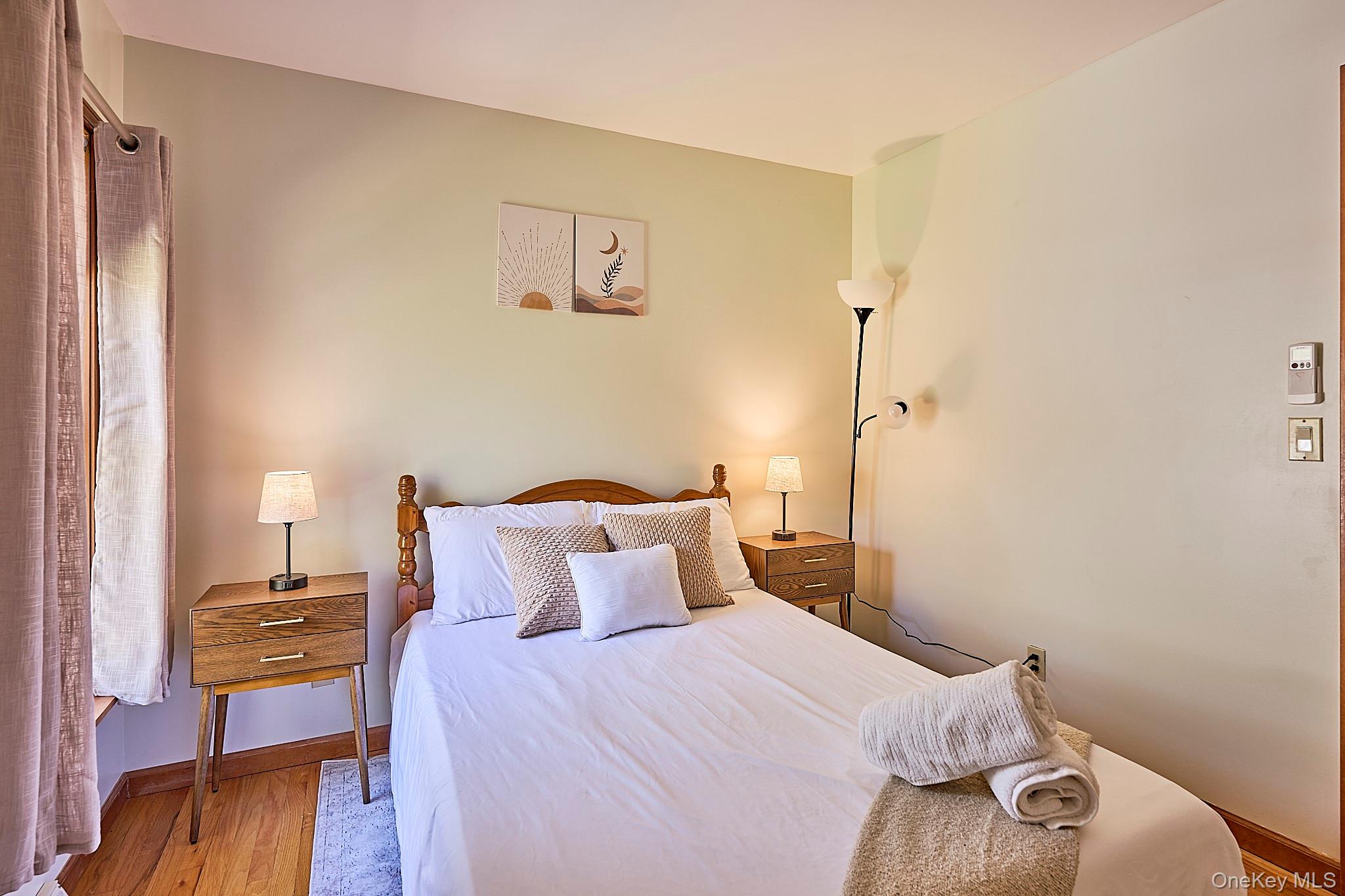 39 Pitio Road Glen Spey, NY 12737 - Photo 18 of 45 a bedroom with a bed and wooden floor