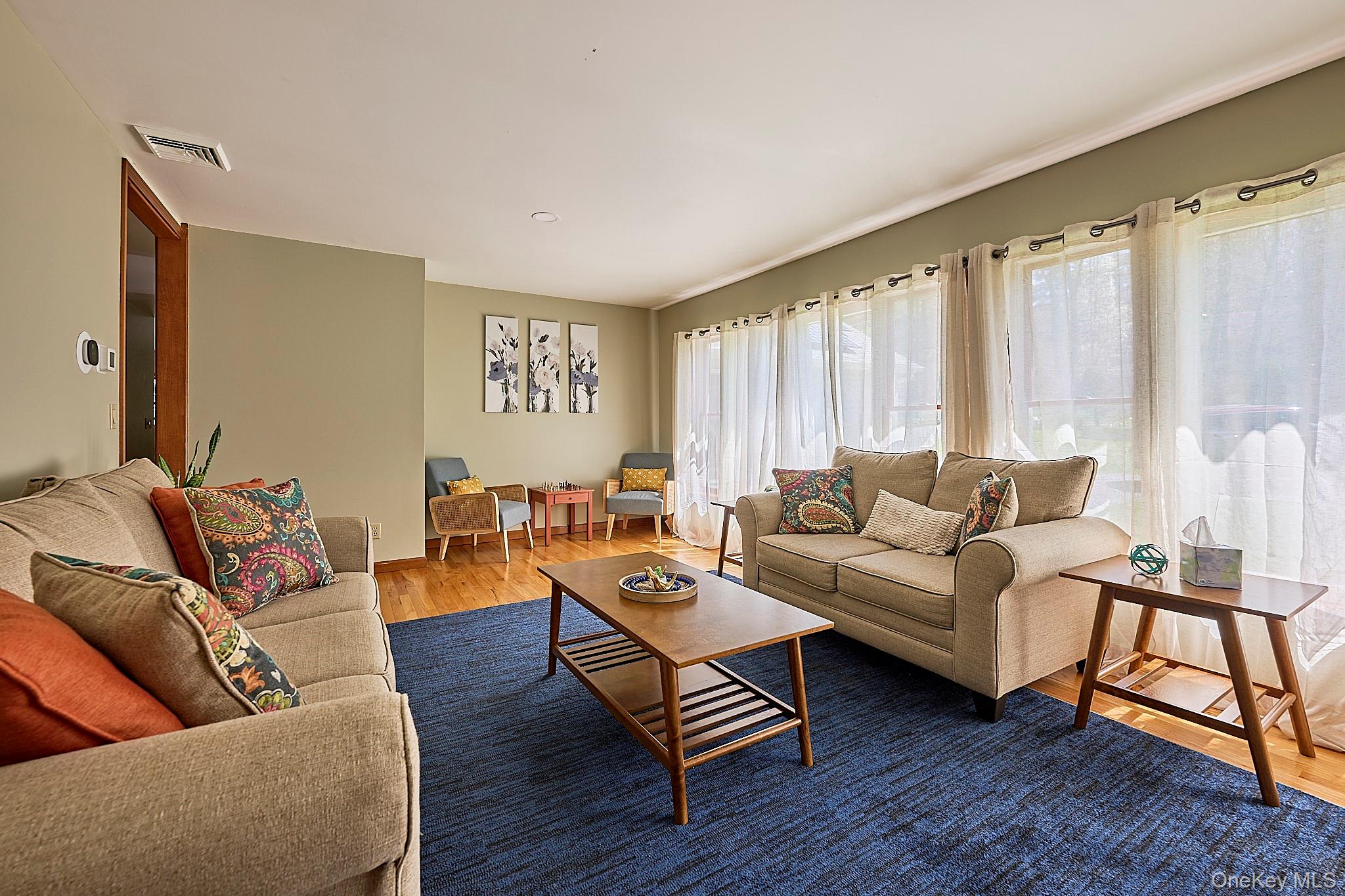 39 Pitio Road Glen Spey, NY 12737 - Photo 8 of 45 a living room with furniture and a wooden floor