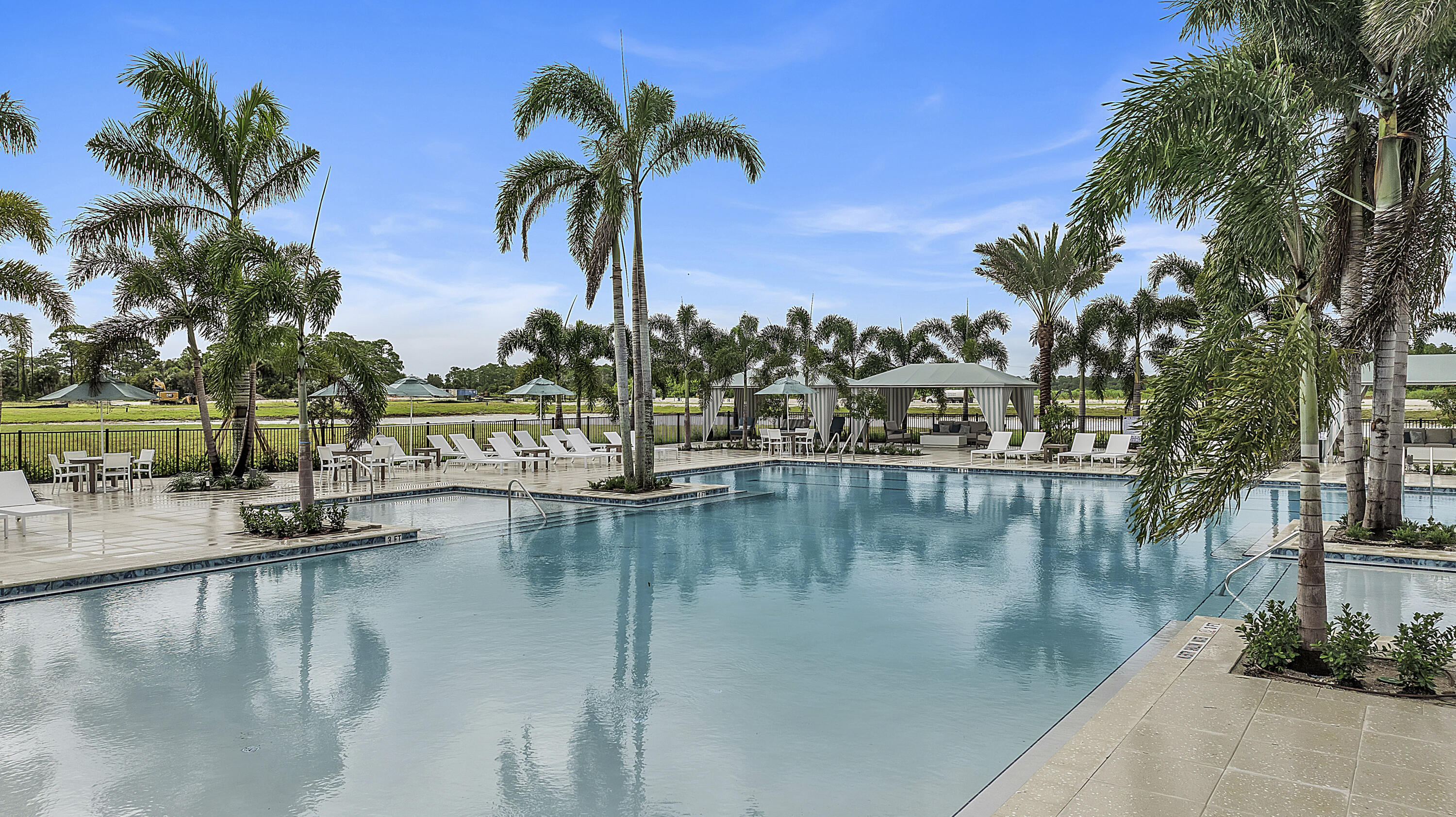 10099 Dreamweaver Road, Unit 51 Port St. Lucie, FL 34987 - Photo 27 of 36 a view of swimming pool with a table and chairs