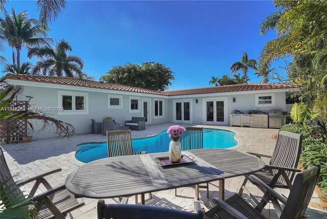 a view of a house with a table and chairs