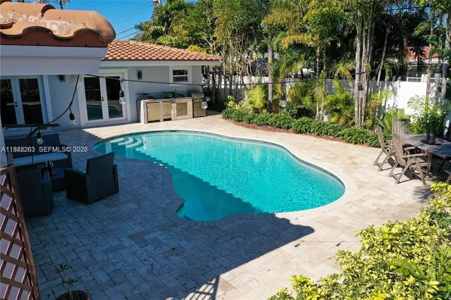 swimming pool view with a seating space