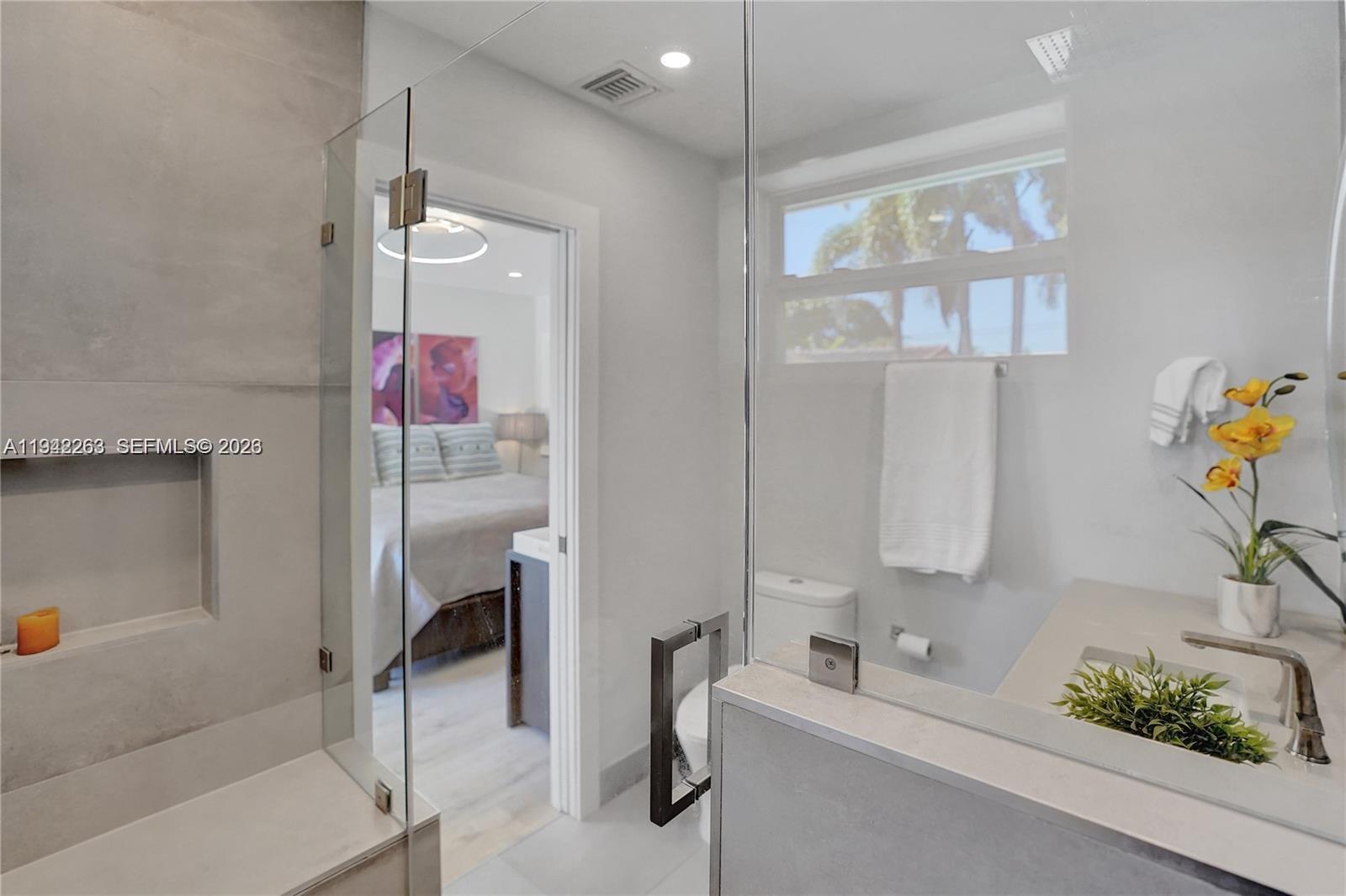 2011 Northeast 31st Court Lighthouse Point, FL 33064 - Photo 21 of 33 a bathroom with a tub sink and mirror