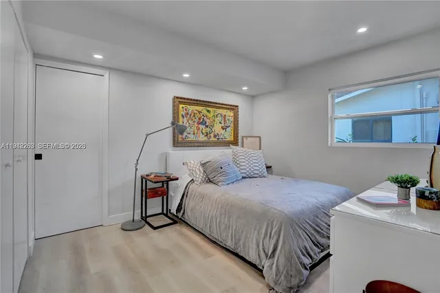 a bedroom with a bed and a potted plant