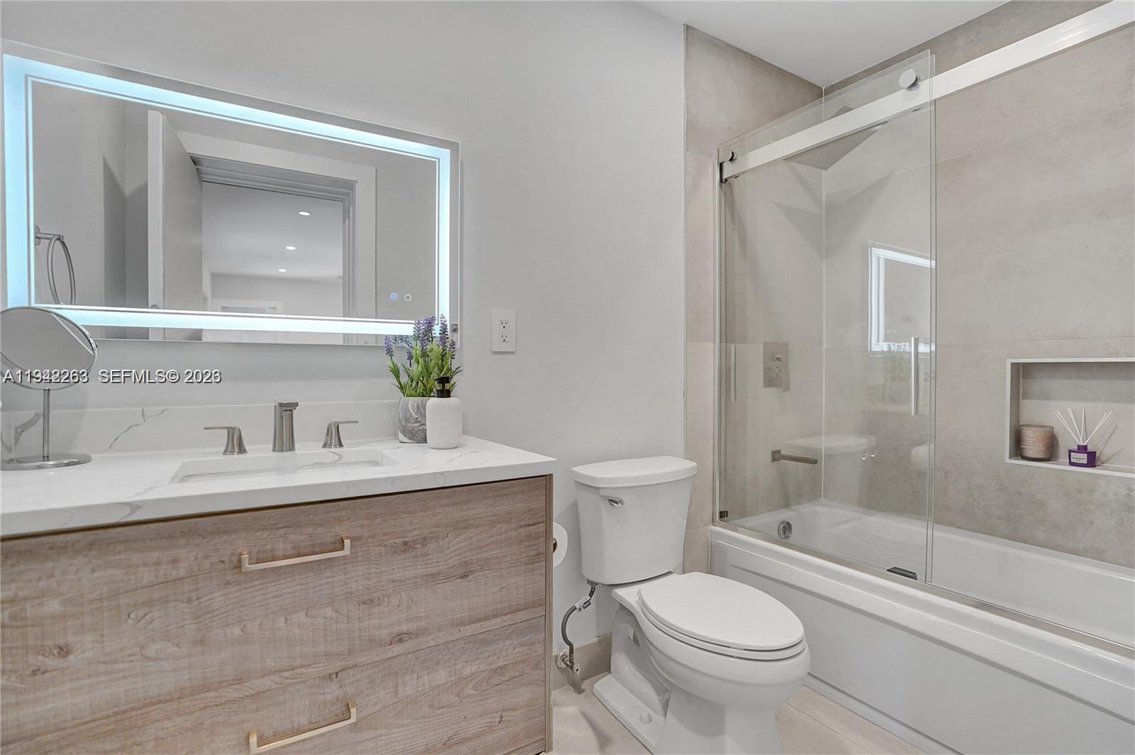 2011 Northeast 31st Court Lighthouse Point, FL 33064 - Photo 30 of 33 a bathroom with a sink toilet and shower