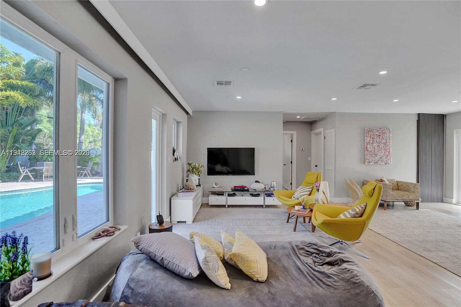 2011 Northeast 31st Court Lighthouse Point, FL 33064 - Photo 5 of 33 a living room with furniture and a flat screen tv
