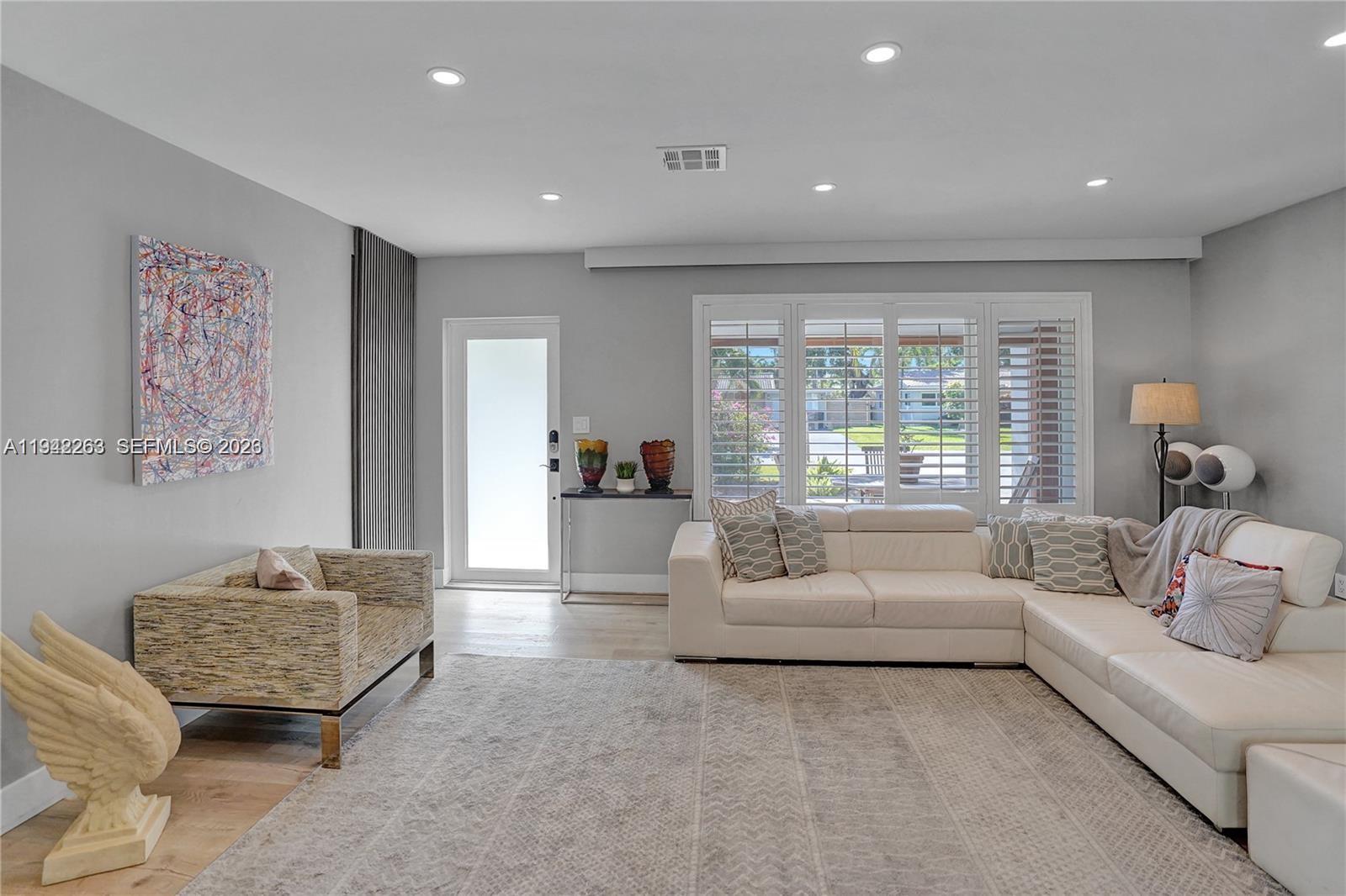 2011 Northeast 31st Court Lighthouse Point, FL 33064 - Photo 6 of 33 a living room with furniture and a large window
