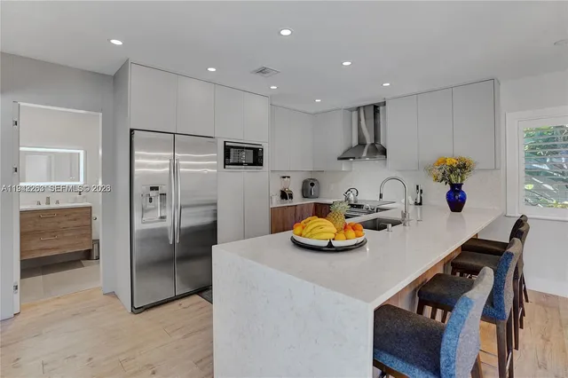 a kitchen with a sink a stove and chairs