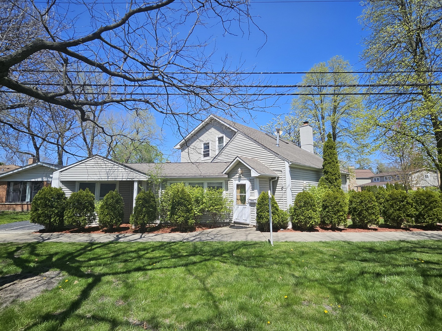a view of a house with a yard and sitting area