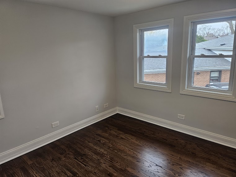 808 Indian Road Glenview, IL 60025 - Photo 13 of 20 a view of an empty room with wooden floor and a window