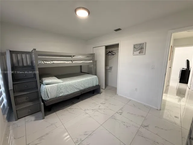 a bedroom with a bed and a cabinets