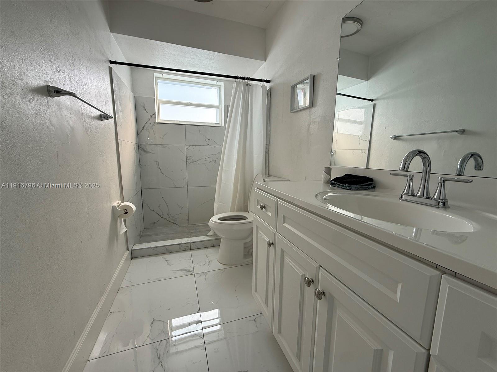 8636 Beekman Drive, Unit 8636 Miramar, FL 33025 - Photo 14 of 18 a bathroom with a sink a toilet and shower